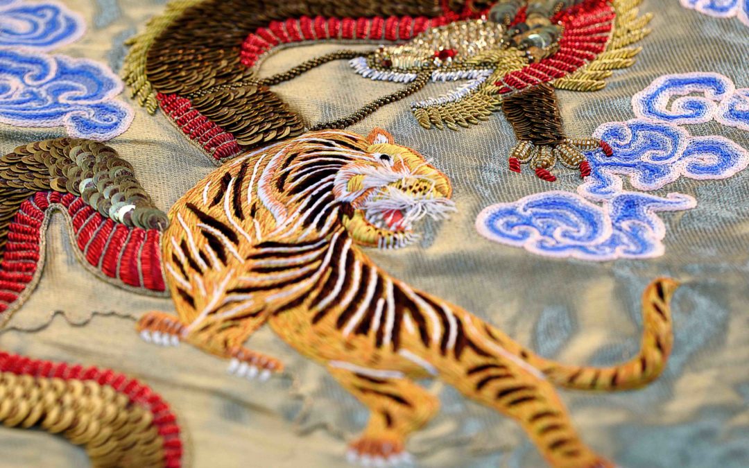 Hand beaded dragon and tiger for a couture garment by Ricamour